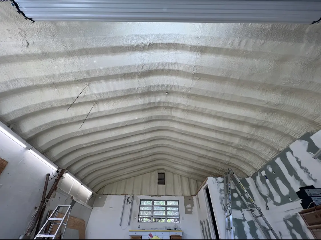 Spray polyurethane foam applied to the underside of a metal roof deck in Red Bank